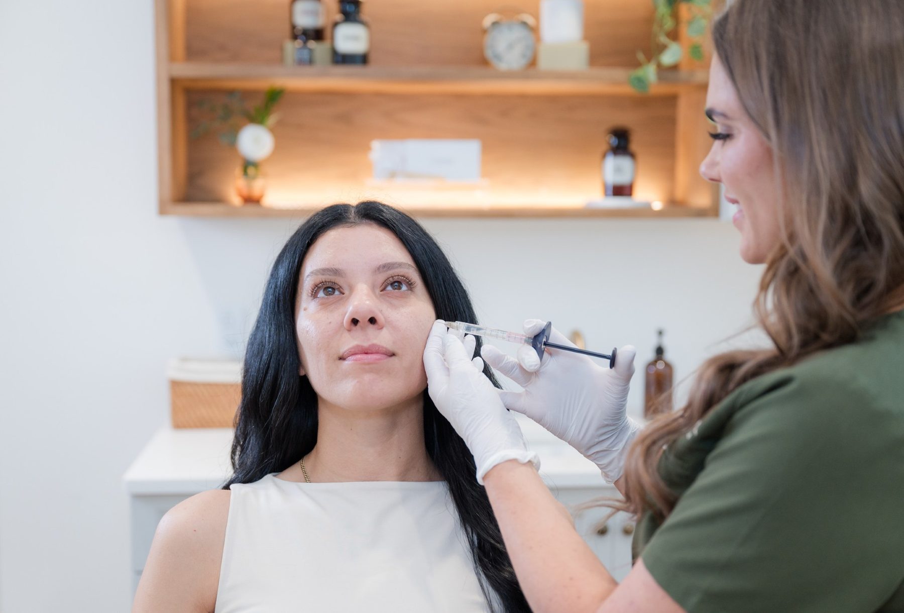 Elixir Aesthetics provider performing an injectable treatment at the cheek